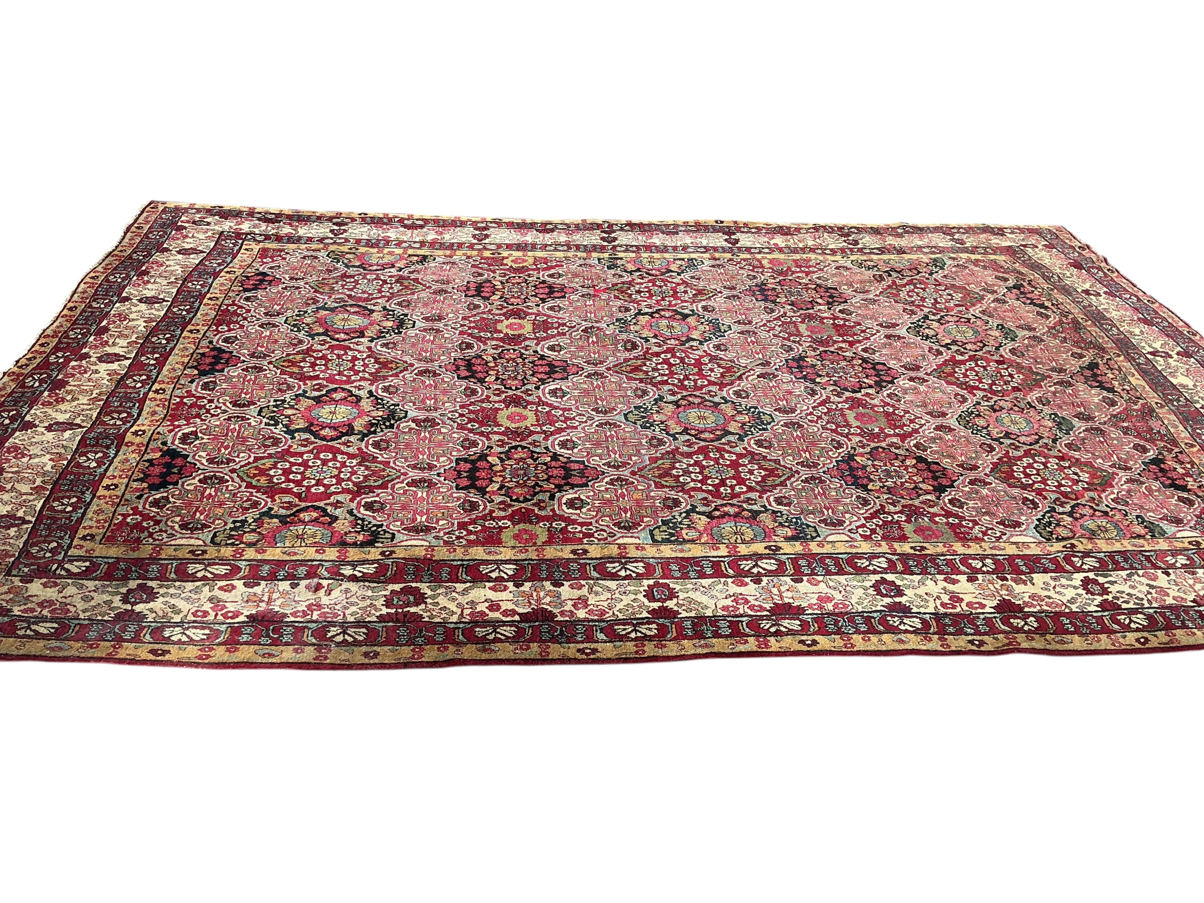 An Agra multi coloured carpet, the ground woven with interlocking oval medallions, 455 x 315cm